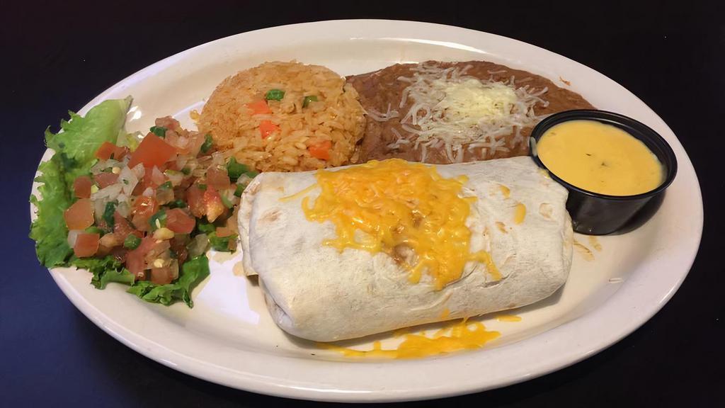 Burrito · Large flour tortilla filled with ground beef or spicy chicken with rice and beans, a side of queso and pico de gallo.