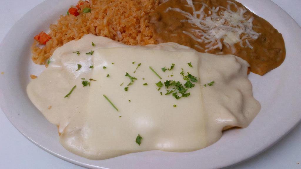 B. Beef Enchiladas · Two ground beef enchiladas topped with chili con carne, jack cheese. All plates served with rice and beans.