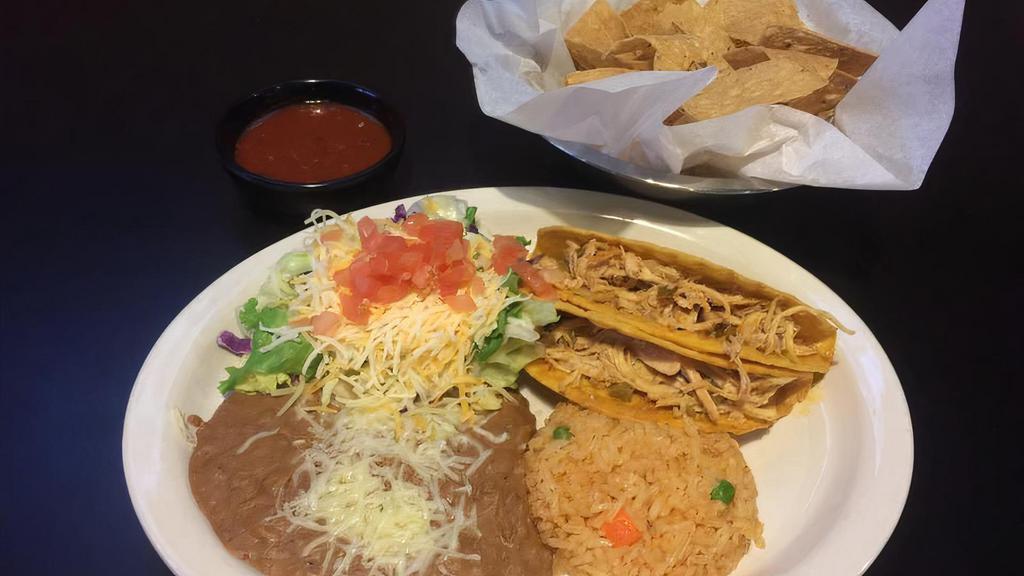 Tacos · Your choice of two crispy or soft, ground beef or spicy chicken. Served with rice and beans along with a side of lettuce, cheese, tomatoes.