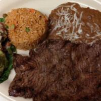 Carne Asada · Grilled marinated skirt steak served with rice and beans along with a side of guacamole, pic...