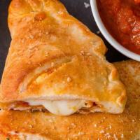 Combo Calzone · Pepperoni, sausage, mushrooms, onions, sweet peppers, tomato sauce, and mozzarella cheese.