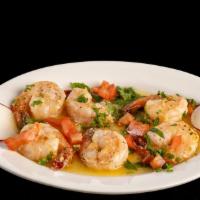 Camarones Al Ajillo · Shrimp sautéed with fresh garlic, Spanish,
herbs, and white wine.