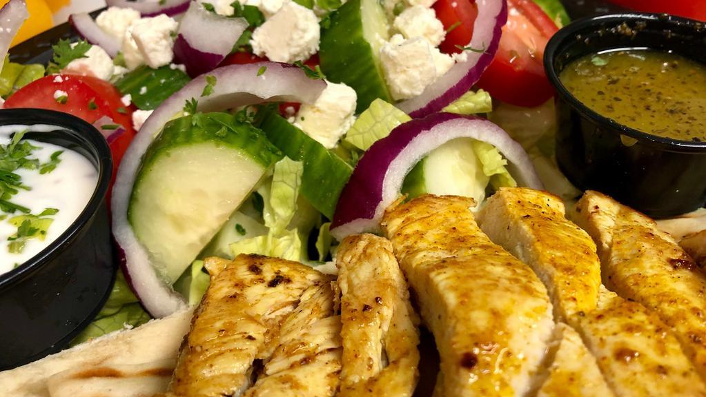 Greek Grilled Chicken Salad On Pita · Freshly chopped Romain garnished with fresh cut tomatoes, cucumbers, red onions, feta cheese, Kalamata black olives, side toasted pita, signature house dressing, cucumber yogurt sauce & choice of 5 oz. grilled chicken breast or crispy chicken tenders.