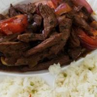 Lomo Saltado · Fresh beef sauteed in oil, red onions, tomatoes, spring onions, and cilantro served on a bed...
