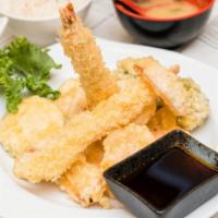 Shrimp Tempura Appetizer · Crispy batter-fried shrimp and vegetables with tempura sauce.