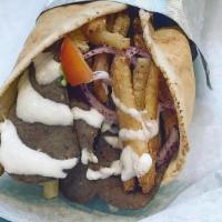 Gyro Wrap · Sliced gyro, lettuce, tomatoes, onions & special sauce wrapped in pita.