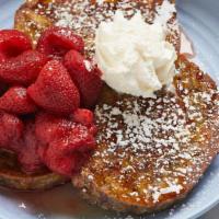Buttermilk Biscuit French Toast · Topped with macerated strawberries, powdered sugar, and a hot honey drizzle, plus a hint of ...