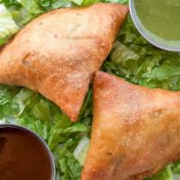 Samosa · 2 vegetarian turnovers stuffed with potatoes, peas, spices, herbs and served with tamarind c...