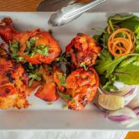 Tandoori Chicken · Chicken on the bone, marinated in yogurt with spices, baked in our Indian clay oven.
