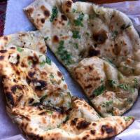 Garlic Naan · Baked bread in the clay oven garlic & cilantro.
