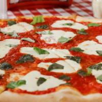 Margherita Pizza · Basil, fresh tomatoes, fresh mozzarella and extra virgin olive oil.