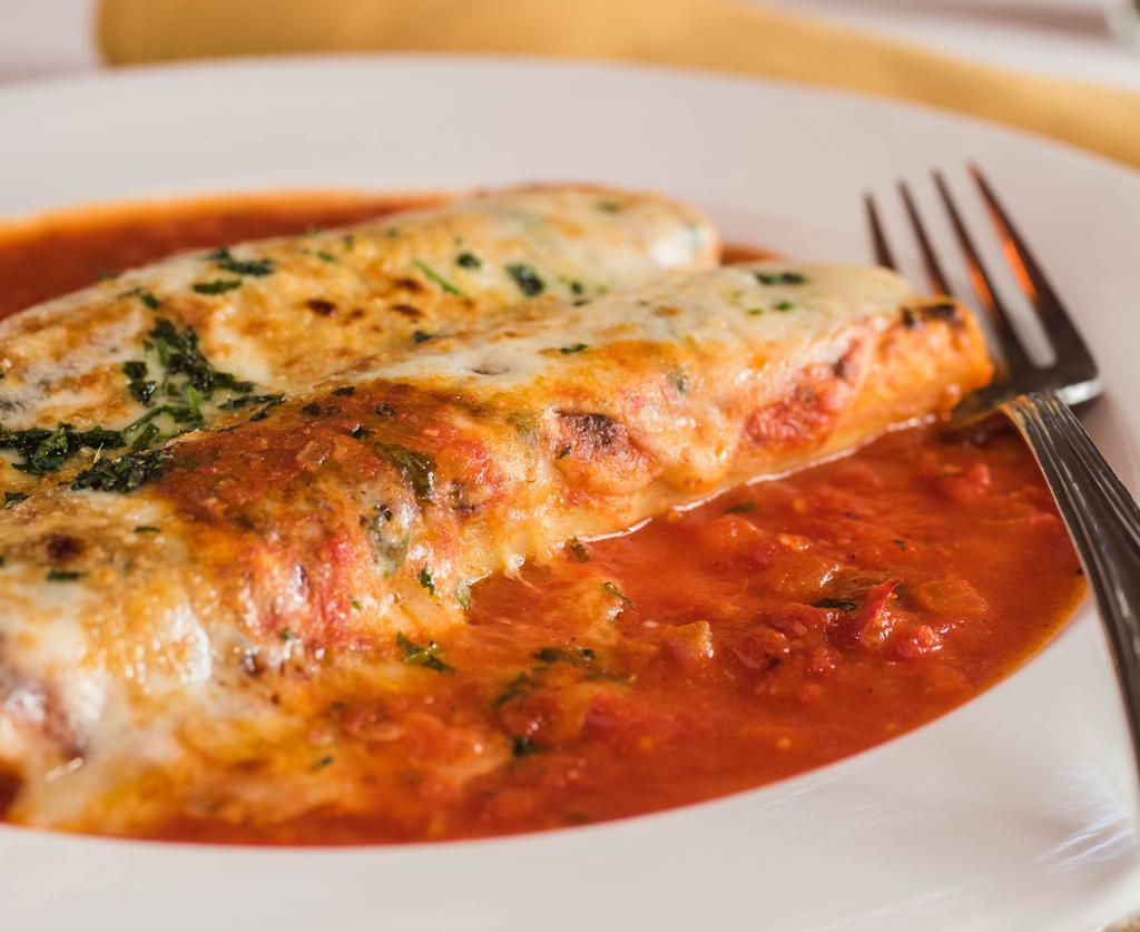 Canneloni Di Carne · Rolled sheets of pasta filled with prime beef in a tomato cream sauce and topped with Mozzarella.