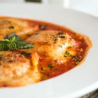 Ravioli Caprese Gratinati · Home made ravioli filled with ricotta cheese, topped with mozzarella, and parmesan cheese in...