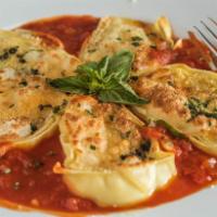 Rondelle 4 Formaggi · Rolled pasta sheets filled with four kinds of cheese, spinach, and tomato sauce.