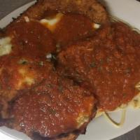 Chicken Parmigiana · Breaded and deep-fried, then baked with a slice of mozzarella, served with pasta and marinar...
