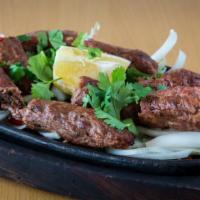 Lamb Seekh Kebab · Minced lamb blended with onions, herbs and spices and then roasted on a skewer