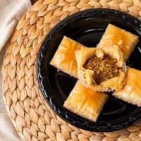 Baklava · Filo dough filled with finely chopped nuts, dressed with rose water syrup.