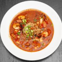 Jambalaya · chicken, shrimp, and andouille sausage in a spicy creole broth over black beans and rice