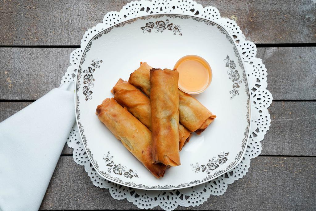 Egg Rolls · Four deep-fried egg rolls wrapped in wonton paper, filled with pork, shrimp, carrot, and glass noodle.