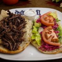 Döner (Gyro) Sandwich · Hand carved thin slabs of lamb and beef combination marinated in our special sauce. Slowly g...