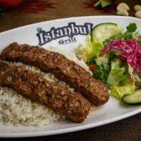 Adana Kebab · Gluten-free. Two skewers of freshly ground lamb, flavored with red bell pepper and slightly ...