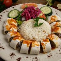 Sultan Kebab · Freshly ground lamb on a skewer char-grilled and wrapped in flat bread, cut into sections, t...