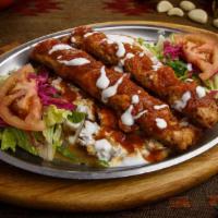 Yogurtlu Tavuk (Chicken) Adana · Two skewers of tavuk Adana kebab, layered on bed of diced butter-roasted bread topped with y...