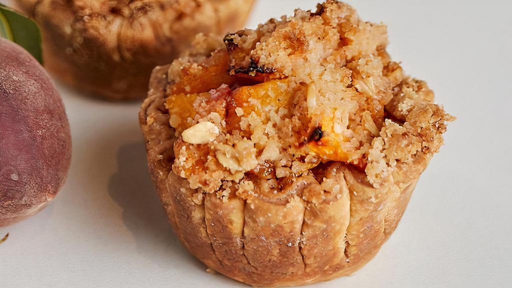 Peach Crumb · Fresh Peaches baked with brown sugar, cinnamon and ginger + topped with our in house crumb topping.