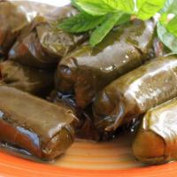 Dolma · Grape leaves stuffed with rice, tomatoes, onions, and parsley slow-cooked with lemon juice a...
