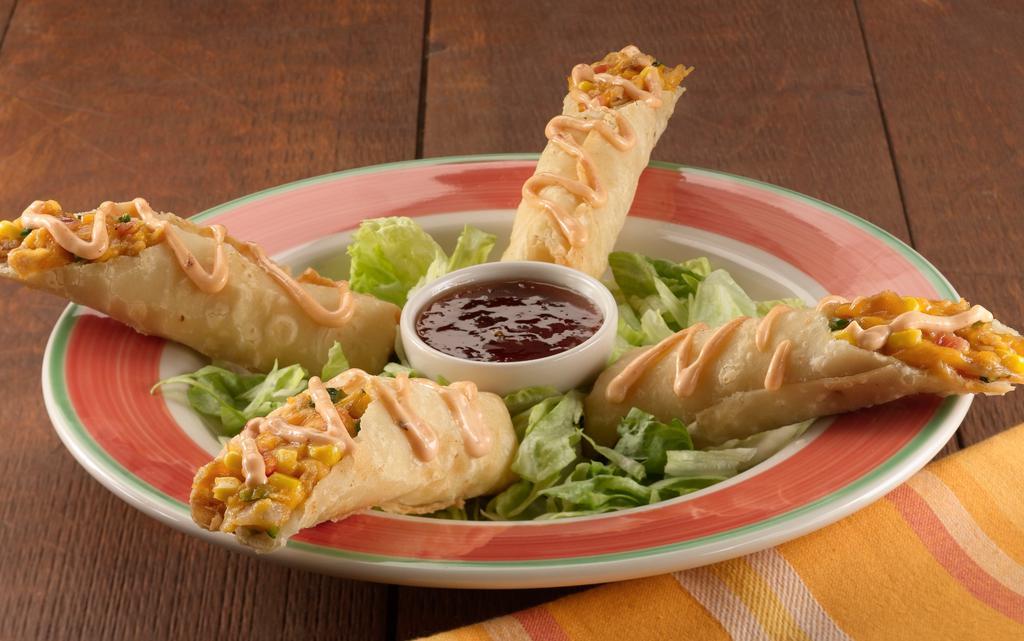 Flautas · Lightly crispy hand-rolled flour tortillas filled with seasoned shredded chicken, roasted red peppers, grilled corn with mild cheddar and Monterey jack cheese. Served with jalapeno jelly sauce for dipping.