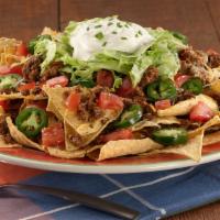 Macho Nachos · Paradiso Specialty. A Paradiso classic! This party on a platter starts with a pile of chips,...