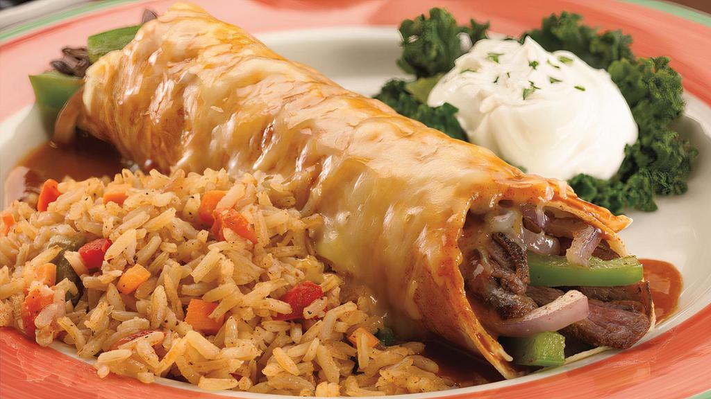 Fajita Burrito · Sizzling tender steak or chicken strips with grilled onions and fresh poblano peppers, stuffed into a large flour tortilla and lavished with red sauce and melted Cheddar and Monterey Jack cheese. Served with Spanish rice and sour cream topping.