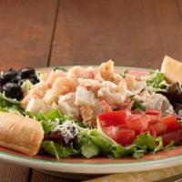 Acapulco Seafood Salad · A delightful blend of seafood served over a bed of fresh lettuce, decorated with a generous ...