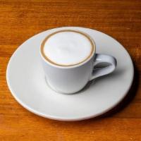 Macchiato · Two shots of espresso, a dot of foam, 2oz total.