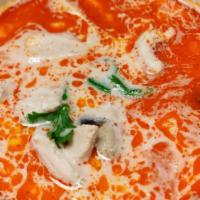 Tom Ka Soup * · Thai style creamy soup simmered with galanga, mushrooms, coconut milk and a touch of thai pe...