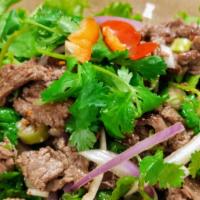 Spicy Beef Salad *** · Sliced grilled beef tossed with hot peppers, onions, lime juice and lettuce.
*** Thai spicy