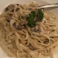Fettuccine Con Pollo & Fungi · Fettuccine pasta and chicken with mushrooms in a light cream sauce
