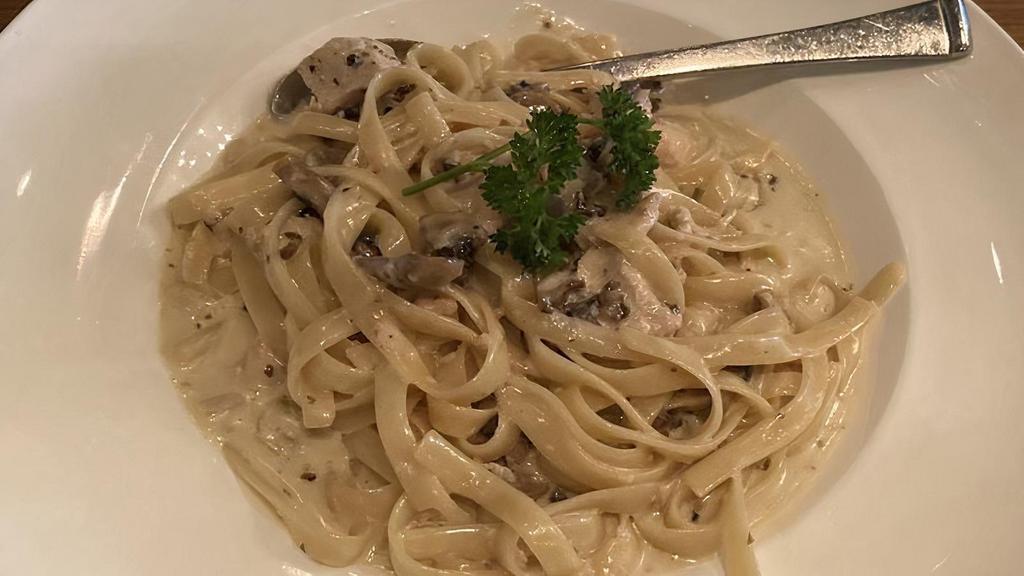 Fettuccine Con Pollo & Fungi · Fettuccine pasta and chicken with mushrooms in a light cream sauce