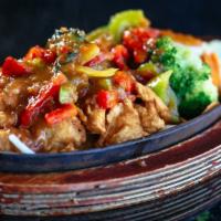 Volcano Chicken* · Breaded, deep-fried chicken breasts and onions with a side of steamed vegetables, topped wit...