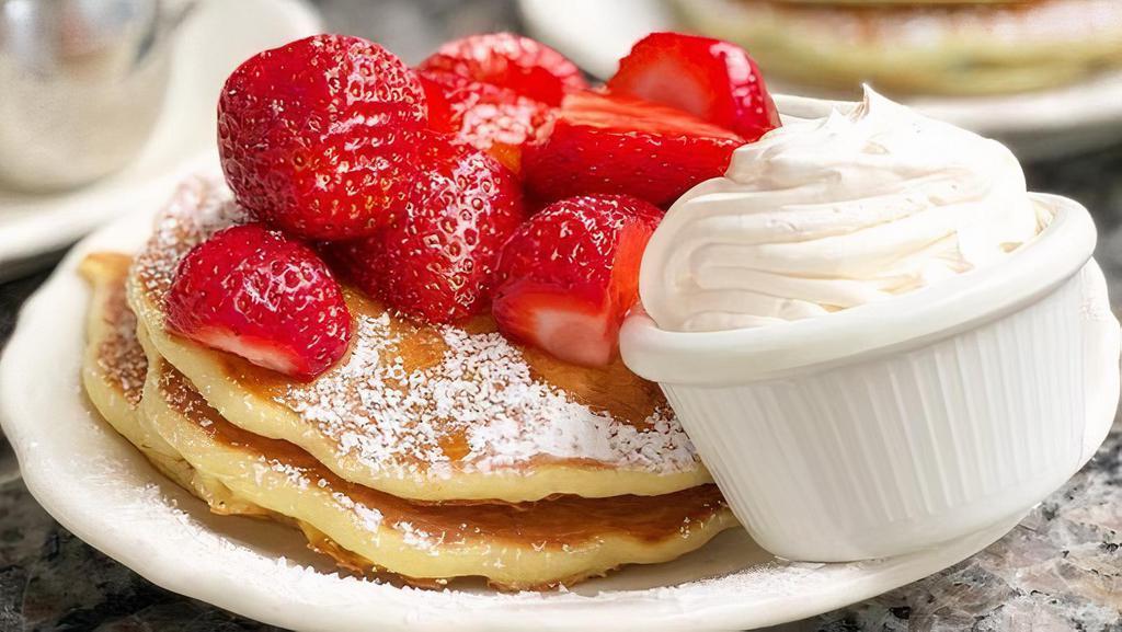 Half Order Fresh Strawberry Pancakes · Buttermilk pancakes topped with fresh sweet strawberries, dusted with powdered sugar, served with real whipped cream and whipped butter.