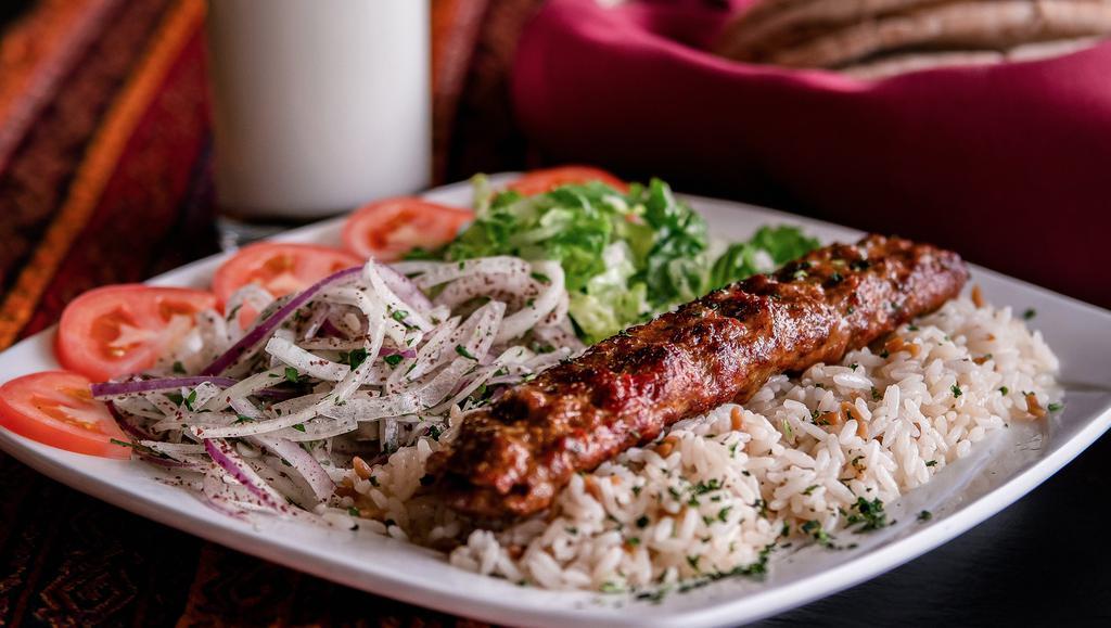 Adana · Ground lamb mixed with fine chopped red bell peppers and grilled on skewer.