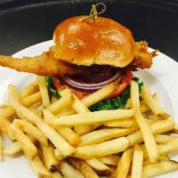 Jack’S Fish Sandwich · Traditional ale-battered haddock, green leaf, tomato, red onion, remoulade, on a brioche bun...