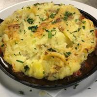 Iron Skillet Cottage Pie · Certified Angus Beef, carrots, peas, onions, fresh herbs, veal demi-glace, topped with white...