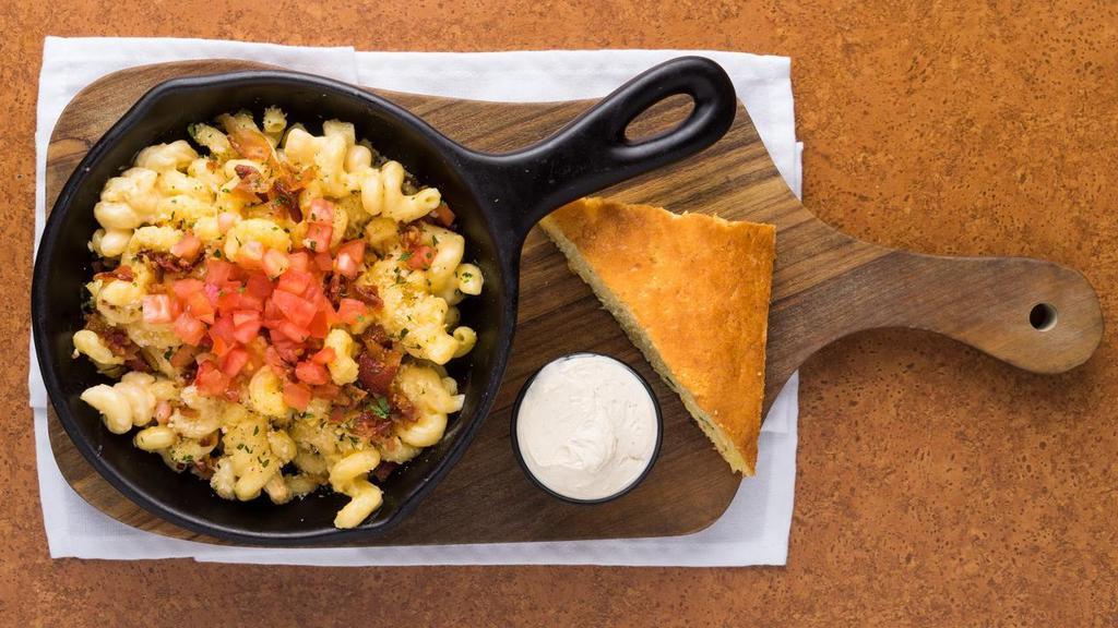House Mac · Made From Scratch Cheese Sauce Tossed With Cavatappi Noodles Then Baked With A Bread Crumb Crust, Diced Tomatoes And Chopped Bacon Finish.