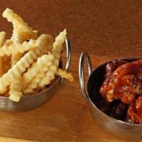 Kid Wings · 6 bone in traditional wings tossed in choice of sauce. Served with choice of ranch or bleu c...