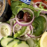 Small Greek Salad · Romaine, onions, cucumbers, green peppers, shredded carrots, cabbage, tomatoes and feta with...