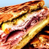 Cuban Panini · Roasted pork, smoked ham and cheese swiss cheese with sliced dill pickles, whole grain musta...