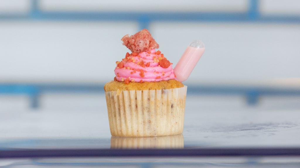 Strawberry Crunch Cupcake · Vanilla Cake with Strawberries mixed in topped with strawberry crumble and strawberry Cream Cheese Icing Infused with Vodka & Tequila Rose