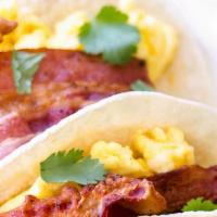 Bacon 🥓 Eggs And Cheese Taco 🌮  · Fresh whole eggs , cheese 🧀 crispy bacon with corn/flour tortillas,