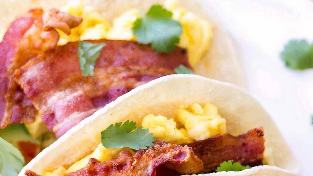 Bacon 🥓 Eggs And Cheese Taco 🌮  · Fresh whole eggs , cheese 🧀 crispy bacon with corn/flour tortillas,